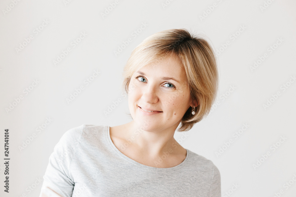 Middle aged woman on light background Middle aged woman on light background