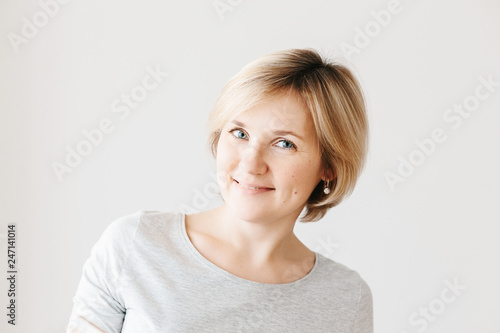 Middle aged woman on light background