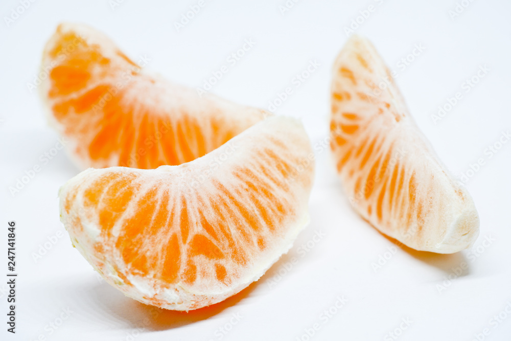 Ripe and juicy tangerine slices on a white background. Ripe and juicy tangerine slices on a white background.