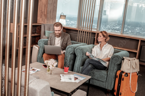 Attentive bearded man typing email to his partner