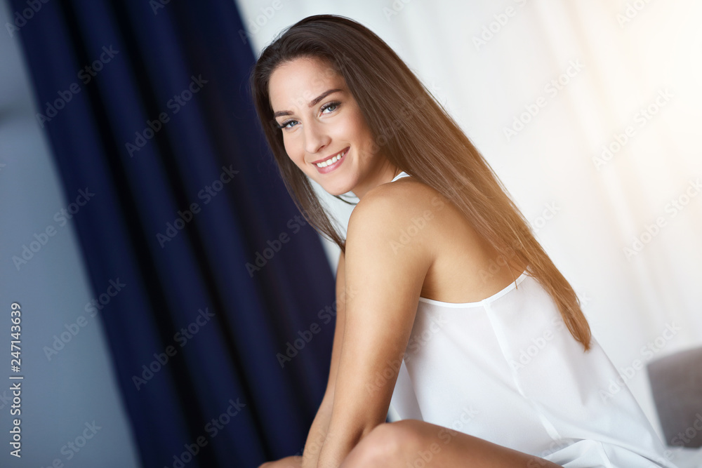 Young beautiful woman waking up in her bed fully rested Young beautiful woman waking up in her bed fully rested