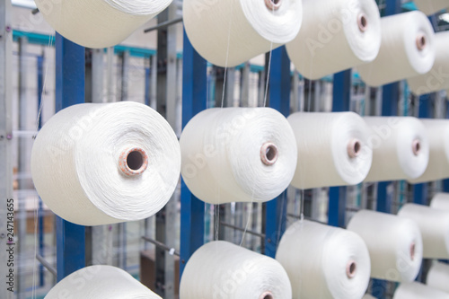 Принти на полотні Group of bobbin thread cones on a warping machine in a textile mill