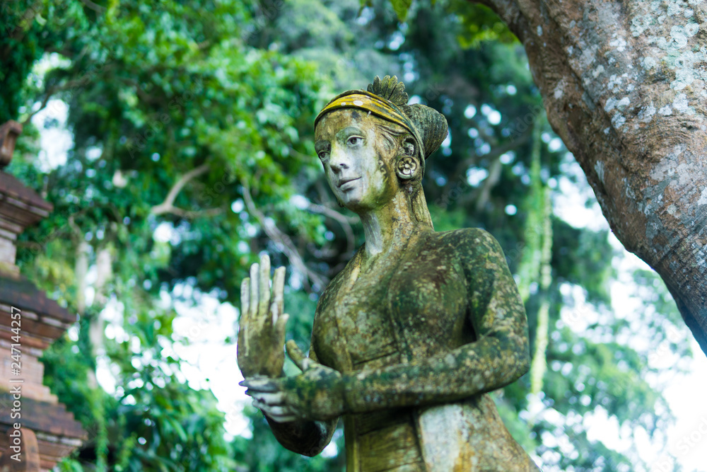 Close up woman statue Indonesian-style, Fairy statue in the garden, lady in the garden, Beautiful woman statue in the park. Taman Tirtagangga temple on Bali