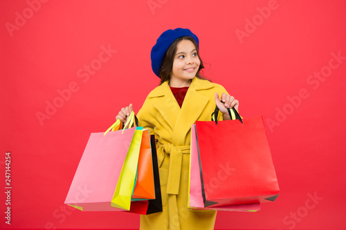 Obsessed with shopping. Girl cute kid hold shopping bags. Get discount shopping on birthday holiday. Nice purchase. Fashionista enjoy shopping. Customer satisfaction. Prime time buy spring clothing