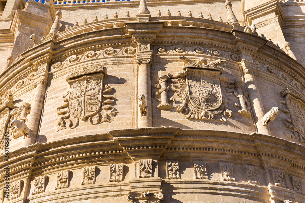 Detail of the cathedral with the image of the coats of arms - the main attraction of the city of Seville, Andalusia, Spain