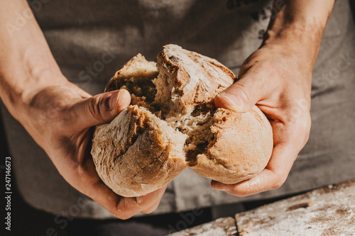 Fotótapéta Baker or chef holding fresh made bread