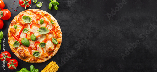 Tasty vegetarian pizza on dark background photo