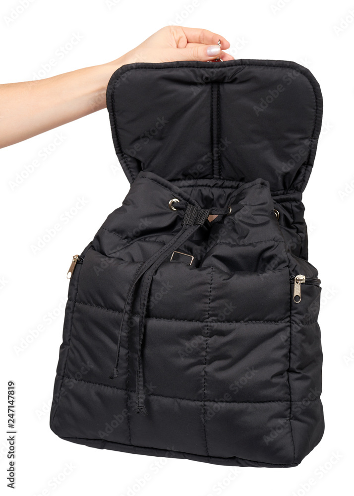 Hand with black textile school bag, city street backpack Hand with black textile school bag, city street backpack