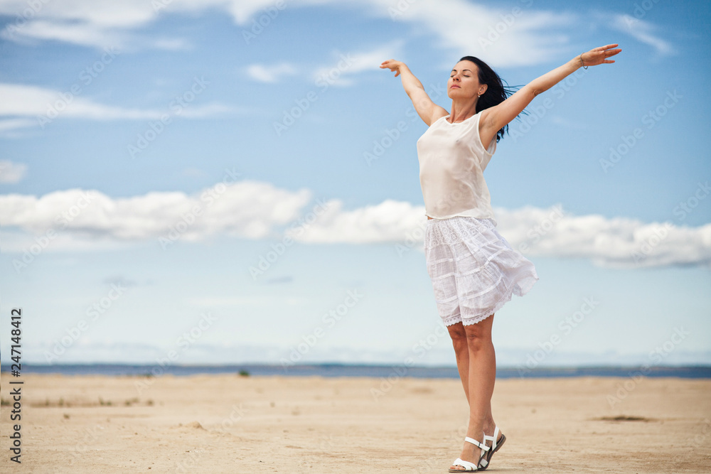 slender brunette in white clothes jumping in the sandy desert slender brunette in white clothes jumping in the sandy desert