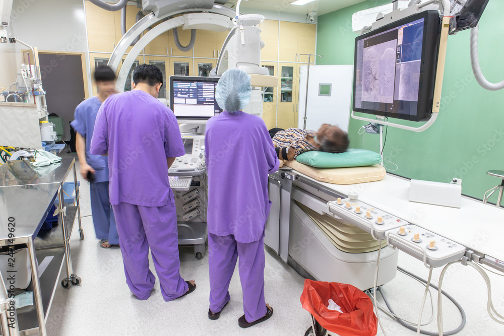 The is a patient examination in Digital Subtraction Angiography Room, DSA lab, operating room with medical scan. Stock 写真 | Adobe Stock