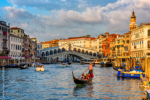 Rialto bridge and Grand Canal in Venice, Italy. View of Venice Grand Canal with gandola. Architecture and landmarks of Venice. Venice postcard