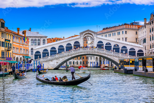 Rialto bridge and Grand Canal in Venice, Italy. View of Venice Grand Canal with gandola. Architecture and landmarks of Venice. Venice postcard photo