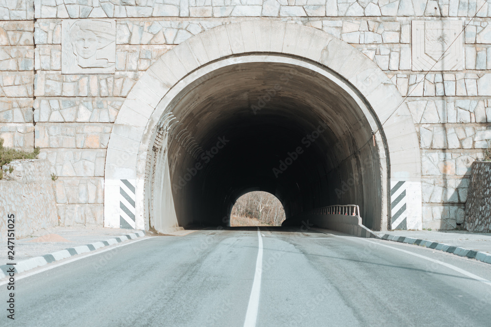 road to the mountains with a tunnel.