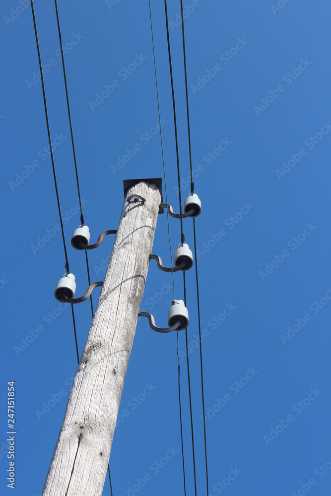 wooden pole with electricity wires in Moordrecht in the Netherlands, which are not common because most wires are underground wooden pole with electricity wires in Moordrecht in the Netherlands, which are not common because most wires are underground