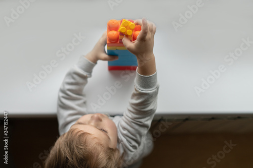 A small child builds figure out the details of child designer