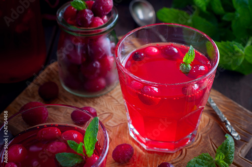 Cranberry juice from frozen cranberries on a wooden board, horizontal