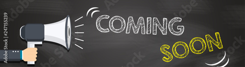 Hand holding megaphone with Coming soon text. Hand holding megaphone with open space for your text.