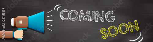 Hand holding megaphone with Coming soon text. Hand holding megaphone with open space for your text.