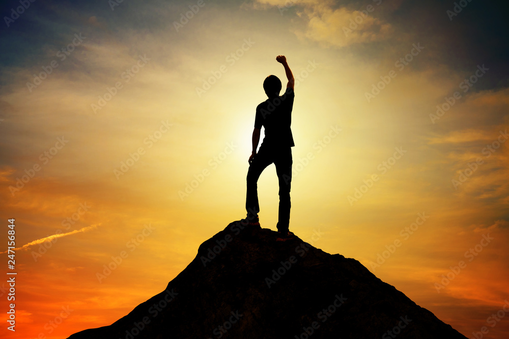 Man standing on top mountain and sunset backgrond outdoor on nature ,leader success winner business concept Man standing on top mountain and sunset backgrond outdoor on nature ,leader success winner business concept