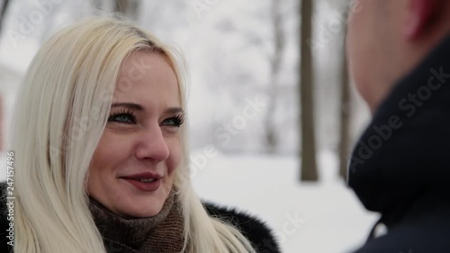 Wallpaper Mural Beautiful young couple holding hands talking and smiling in a city winter park. Torontodigital.ca