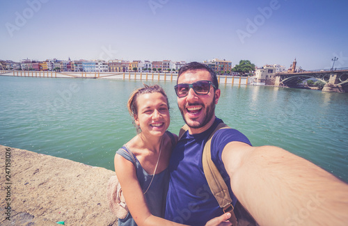 happy smiling tourist take photo selfie in the street of Sevilla, Spain
