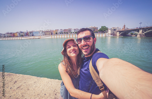 happy smiling tourist take photo selfie in the street of Sevilla, Spain