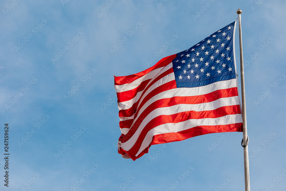 American flag on the blue sky with clouds American flag on the blue sky with clouds