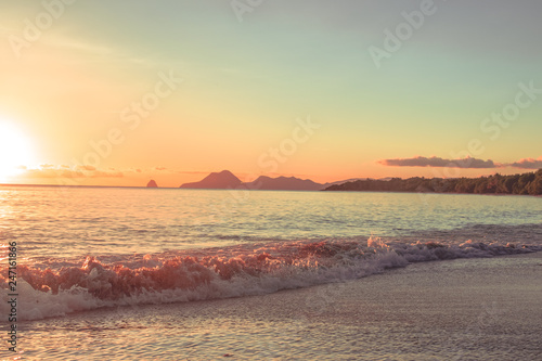 Fototapeta Naklejka Na Ścianę i Meble -  Wave on the beach at sunset on Martinique