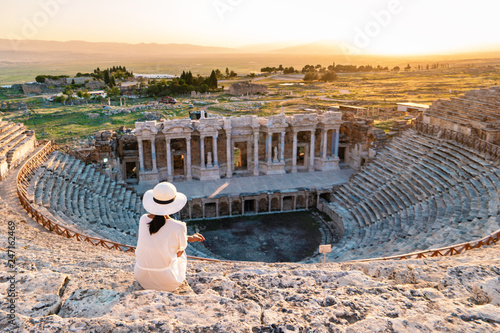 Hierapolis ancient city Pamukkale Turkey, young woman with hat watching sunset by the ruins Unesco  photo