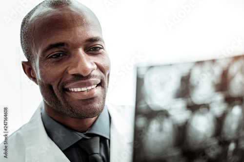 Close up of pleased medical worker that watching roentgen