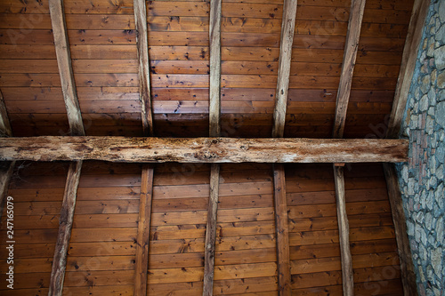 Wooden hand made roof in old, stone built country house in Italy.