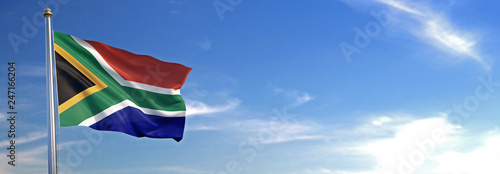 Flag of South Africa rise waving to the wind with sky in the background