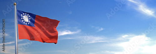 Flag of Myanmar rise waving to the wind with sky in the background