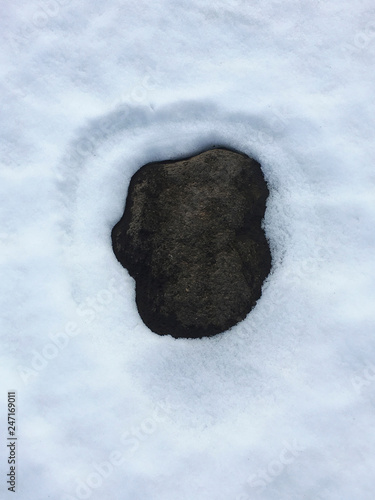 Stone covered with snow