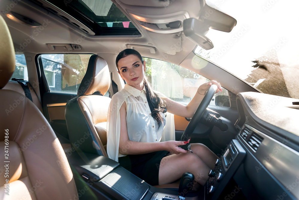 Beautiful woman inside car holding steering wheel Beautiful woman inside car holding steering wheel