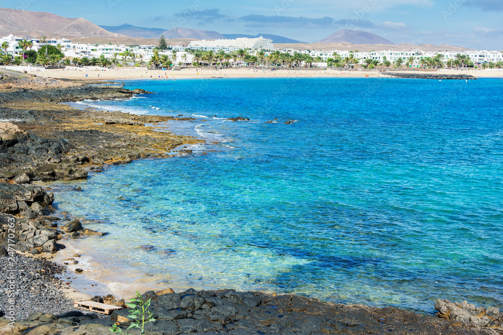 View of Playa de las Cucharas beach in Costa Teguise, Lanzarote, Spain, turquoise waters, selective focus