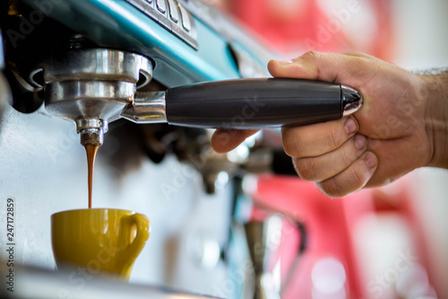 men's hands doing espresso in a cafe