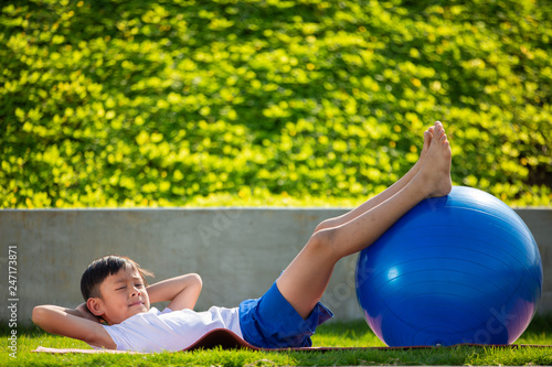Little sporty boy and girl playing exercise or fitness outdoor, stretching muscle gymnastic