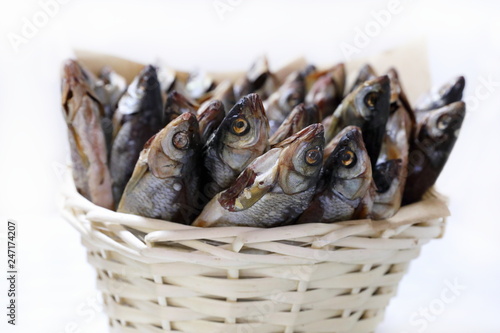 Photography Dried fish to beer close-up in wicker basket