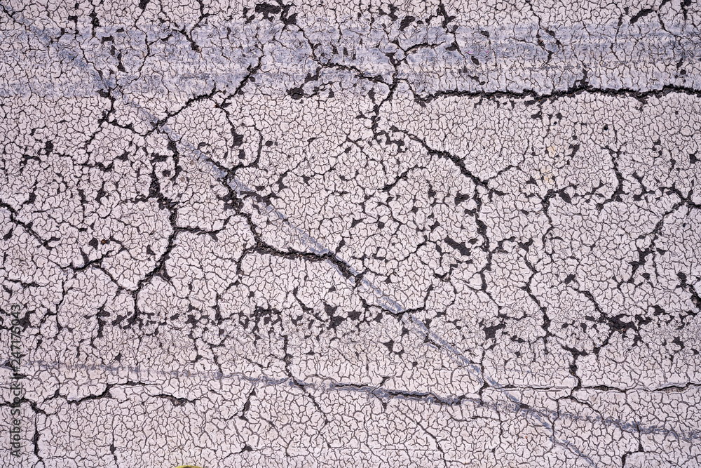 close up of cracked paint on the street for backgrounds close up of cracked paint on the street for backgrounds