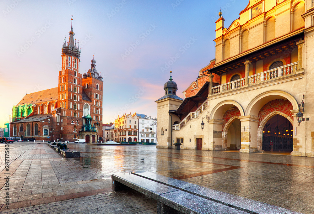 Old city center view with Adam Mickiewicz monument and St. Mary's Basilica in Krakow on the morning