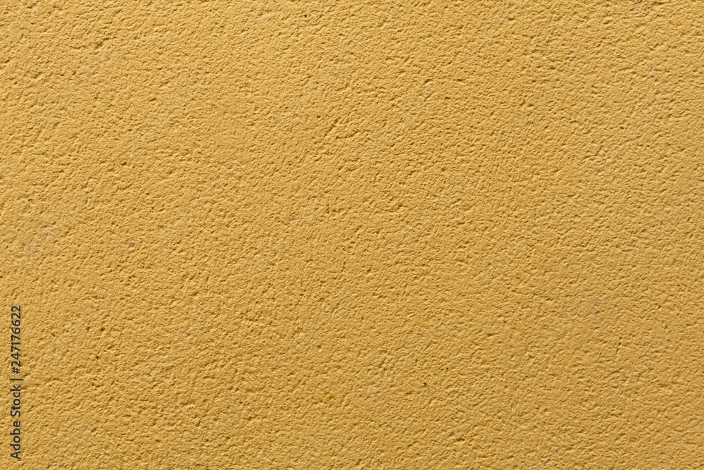 Yellow ochre painted stucco wall. Background texture. Yellow ochre painted stucco wall. Background texture.