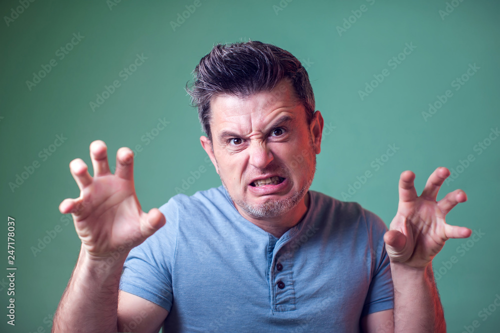 Fototapeta premium Young man trying to scare someone. People, emotions, lifestyle