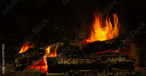 A glowing fire in the stone fireplace