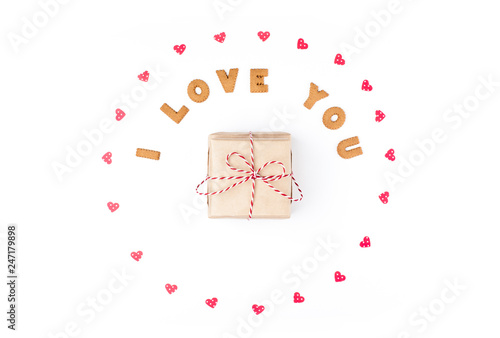 Valentine's day concept. Declaration of love, frame made of paper hearts. In the center gift in craft paper. Flat lay, top view, white background, isolated, copy space