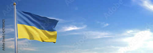 Flag of Ukraine rise waving to the wind with sky in the background photo
