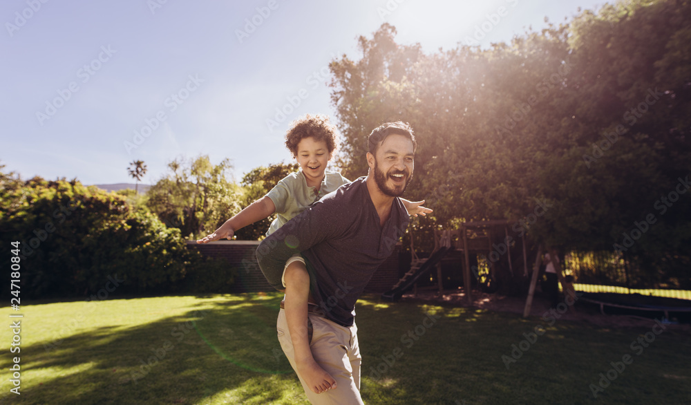 Father and son having fun playing in the park Stock Photo | Adobe Stock