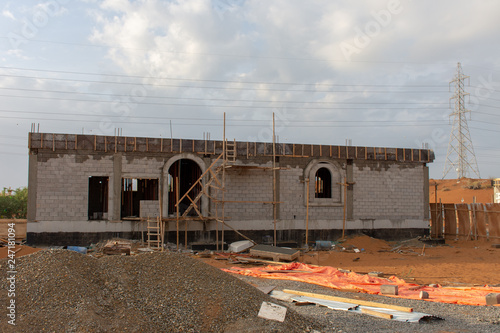 Construction site in the United Arab Emirates at sunset shows new building.