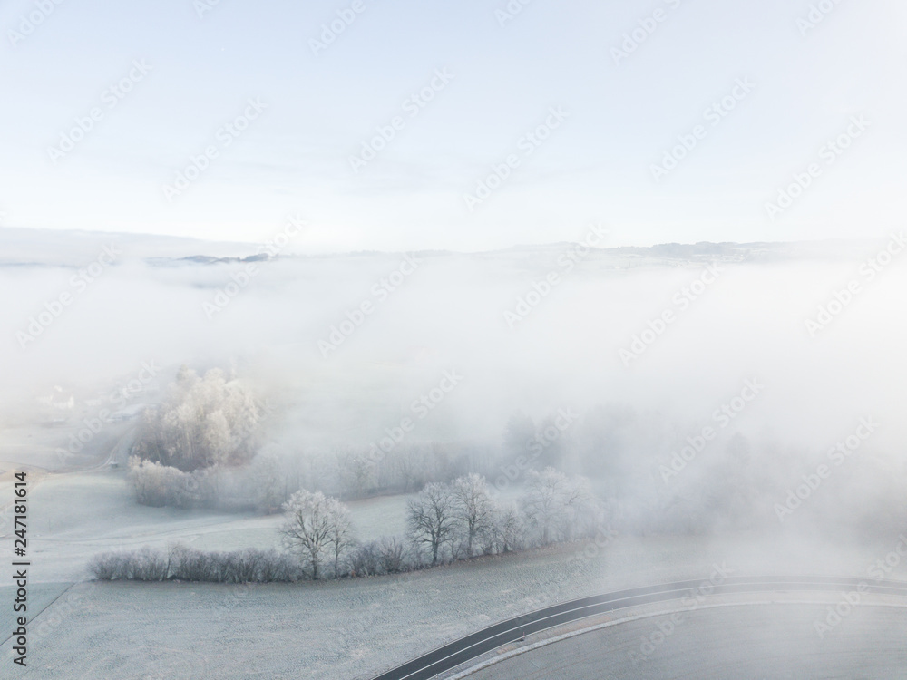 Aerial view of road through fog.