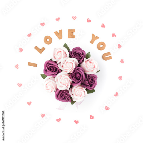 Valentine's day concept. Declaration of love, frame made of paper hearts. In the center flowers in a box. Flat lay, top view, white background, isolated, copy space